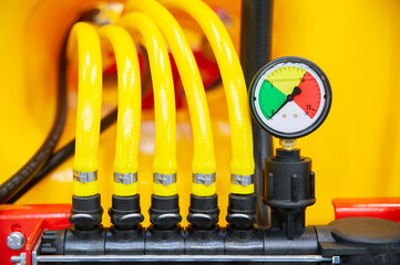Close-up of pressure indicator and yellow high pressure lines