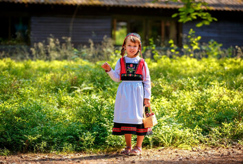 Adorable little girl in Swedish traditional clothes during Midsommar festival - 502481835