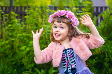 Adorable little girl wearing flower crown and playing outdoors - 502481839