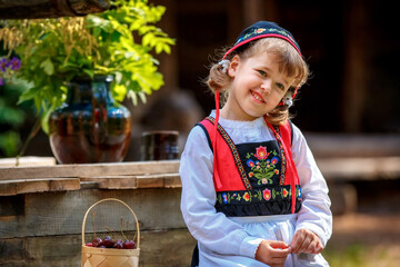 Adorable little girl in Swedish traditional clothes during Midsommar festival - 502481841
