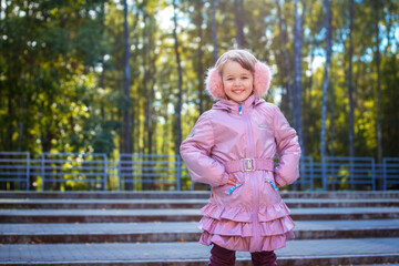Cute happy little girl walking in city park - 502481877