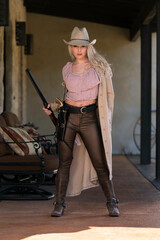 A Lovely Blonde Model Dressed As A Cowgirl Enjoys The American West