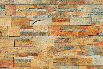 texture of a stone wall. Earth coloured slate stone background. Stone texture wall cladding for...