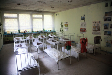 Fototapeta na wymiar A bedroom in a kindergarten in the abandoned city of Pripyat, after the accident at the Chernobyl nuclear power plant. Pripyat, Ukraine.
