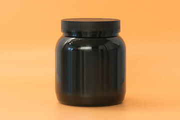 The man's hand holds a wide black protein jar supplement bottle on a yellow background. Protein. Supplement. Workout. Package. Tablet. Plastic. Pill. Vitamin. Pharmacy. Care. Drug. Power