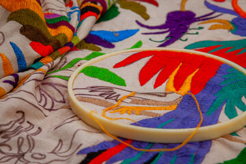 Extreme Close up photo of Tenango, one of the traditional fabrics of Mexico, in the process of embroidery