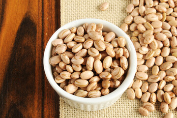 Carioca beans bowl on the jute fabric and wooden table.