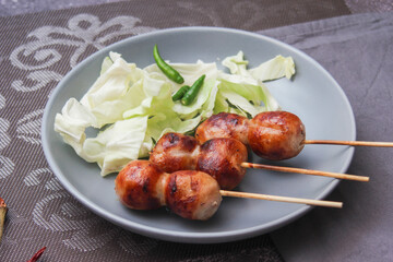 Grilled fermented pork and sticky rice sausage or Sausage Northeastern Style, What we call "Sai Krok Isan" Street food in Thailand.