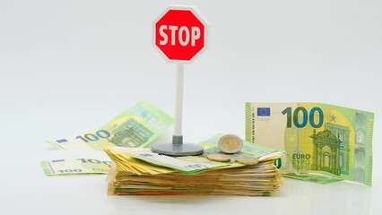 Stop euro currency. Refusal to pay in euros. banknotes, falling euro coins and red stop sign on white background. The fall and depreciation of the euro currency.euro money inflation.4k footage