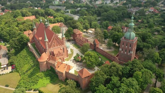 Aerial 4K video from drone to of old town of Frombork on a beautiful summer day. 
There is a wonderful view of Frombork Castle,Baltic Sea and the churches. Frombork
,Poland, Europe. (Series)
