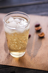 Chrysanthemum Juice, chilled, served in a clear glass placed on a black table