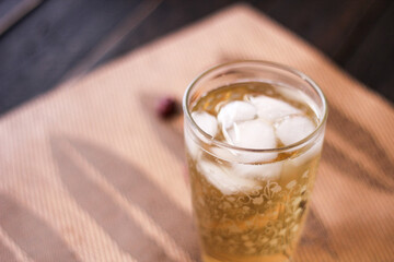 Chrysanthemum Juice, chilled, served in a clear glass placed on a black table