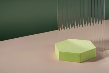 Acrylic ribbed plate, hexagon podium, background for cosmetic product packaging on green backdrop....