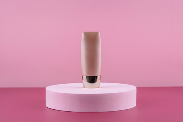 Beige concealer base cosmetics product mock up on pink background. Cosmetic liquid foundation nude cream bottle mockup on round podium pedestal. Skincare beauty primer, bb cc corrector