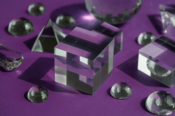 Crystal prism refracting light, magic crystals and pyramid, sphere and cube on purple background....