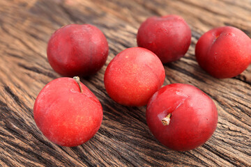 Ripe plums, fresh red plums on wooden table. background of beautiful home plums