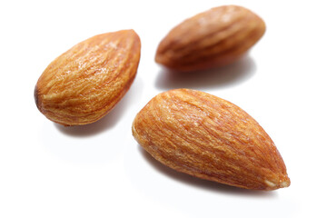 Sugar coated caramelized almonds from above on white background.