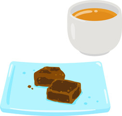 皿に盛った黒糖とお茶