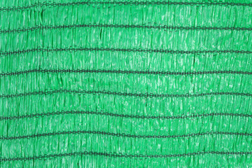 Closeup of shading net for covering rain, sunlight and protecting plants. green shading net texture background.