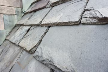 Close up of slate roof tiles on a historic building. Slate is an exceptionally durable traditional building material. 