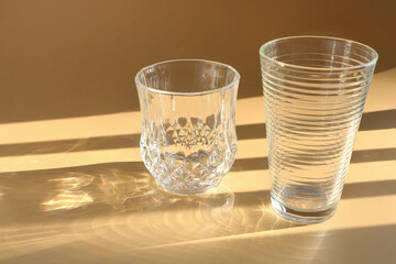 Two glasses of water on the cream color background. Sparkling glasses of water with natural...