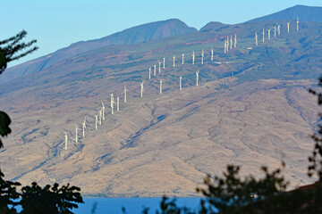 Windmills lining the mountain ridge in Maui, Hawaii - Powered by Adobe