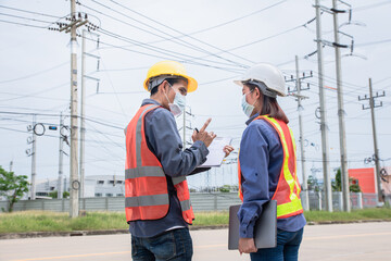 Two Asian Electrician on site service inspection power system station