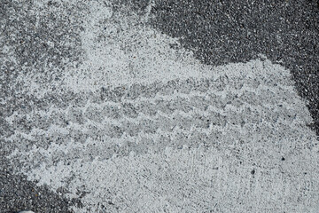 White tire footprint on asphalt, grey road with white painted color, no person