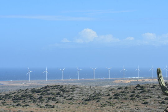 island scene with desert and wind turbine sustainable energy