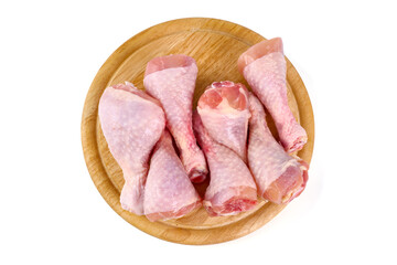 Raw chicken leg quarters on wooden plate, isolated on white background
