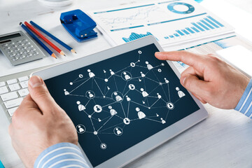 Men's hands hold a computer tablet