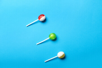 Tasty lollipops on blue background