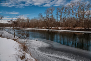 Melting ice on the river in early spring. Landscape of early spring.