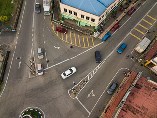 Aerial drone view of vehicles on the street from top view in Selandar, Jasin, Melaka, Malaysia.