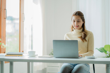 Asian woman working on virtual computer at desk Small business owners, people, employees, freelancers, online, SME, marketing, ecommerce, internet marketing concepts.