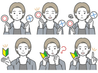 〇✕マークや初心者マークを持つ若い男性