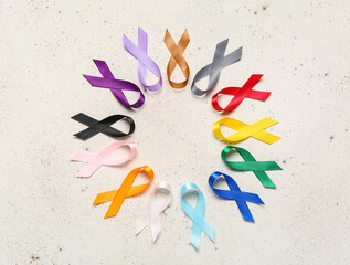 Circle frame made of awareness ribbons on light background. World Cancer Day concept