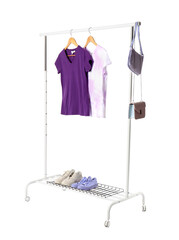 Rack with t-shirts, bags and shoes on white background