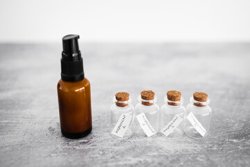 natural beauty and organic ingredients in skincare, amber skincare bottle with small bottles of ingredients next to it