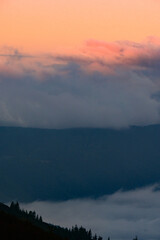 Dawn in the mountains, clouds covered the slopes of the Carpathians.