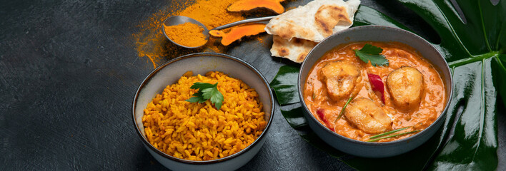 Kerala fish curry on dark background.