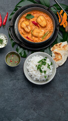 Kerala fish curry on dark background.