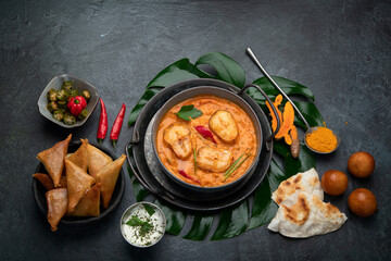 Kerala fish curry on dark background.