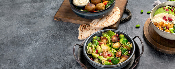 Brussel sprout salad with bulgur on dark background.