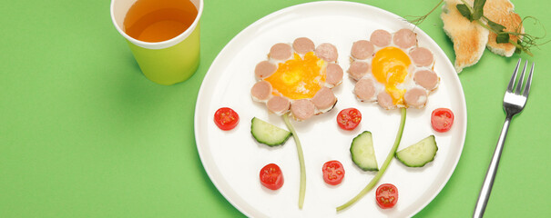 Sunny-side-up eggs with sausage for kids on colourfull background.