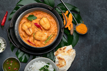Kerala fish curry on dark background.
