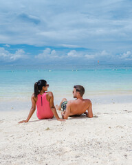 Le Morne beach Mauritius Tropical beach with palm trees and white sand blue ocean couple men and...