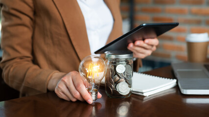 idea and creative concept for business woman hand holding light bulb Idea saving energy and accounting finance concept ..