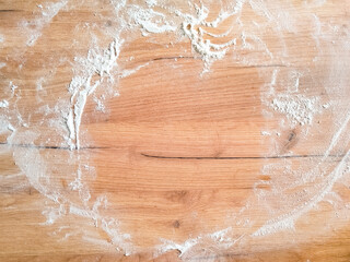 White flour on wooden table. Free space for text. View from above. Top view