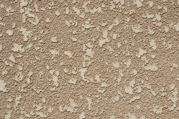 Decorative beige surface of a wall outside. Close up of textured background. Decorative materials and plaster concept.         